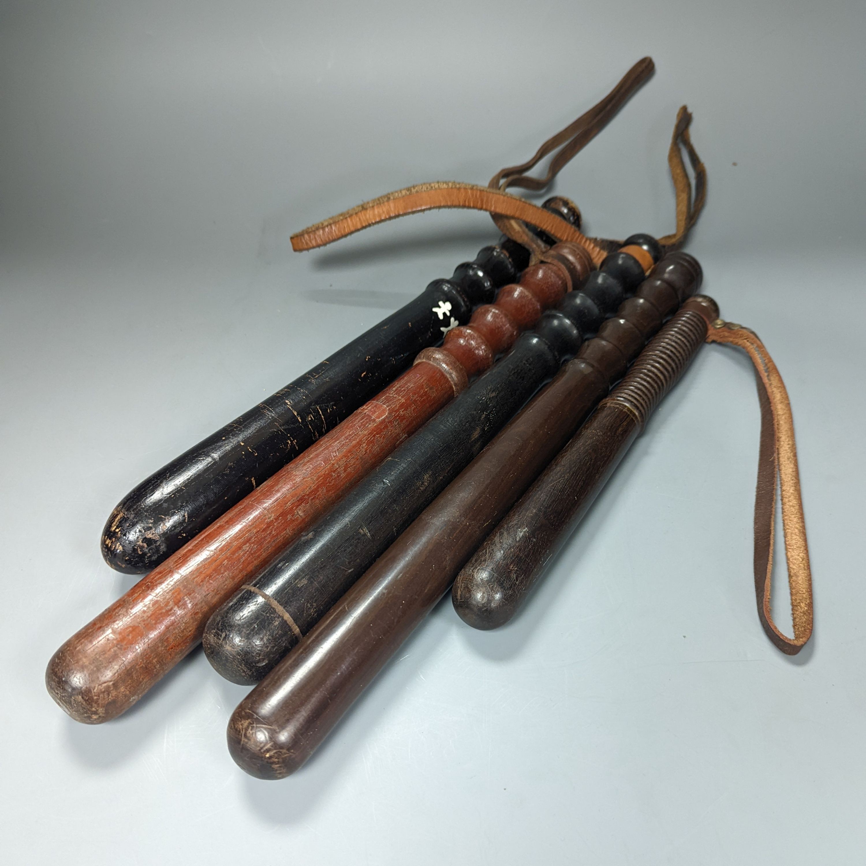 A collection of five 19th century and later wooden truncheons, largest 39 cms long.